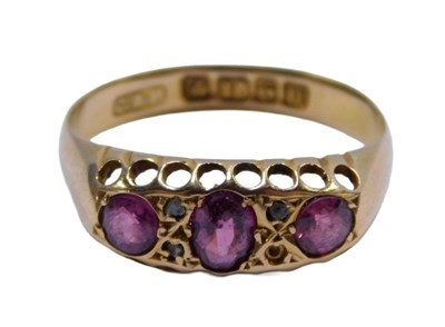 Lot 218 - An 18ct gold gypsy ring, set with three...