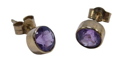 Lot 220B - A pair of amethyst stud earrings, each in a...