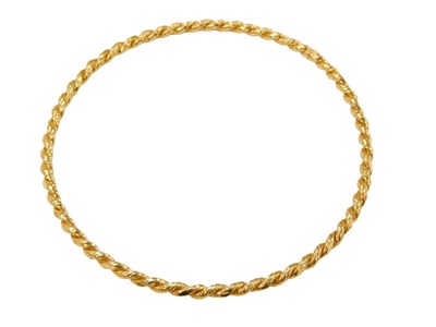 Lot 465 - A twist design gold plated bangle, yellow...