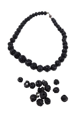 Lot 473 - Various jet carved beads, mainly forming a...