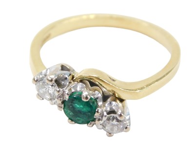 Lot 14 - An 18ct gold emerald and diamond twist ring,...
