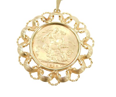 Lot 214 - A George V full gold sovereign pendant and...