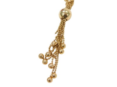 Lot 215 - A trapeze style drop pendant, the central bead...