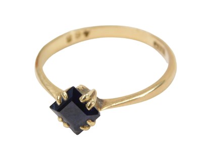 Lot 217 - A sapphire dress ring, set with square cut...
