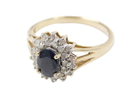 Lot 250 - A cluster ring, set with oval cut sapphire,...