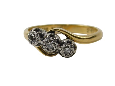 Lot 268 - A three stone diamond twist ring, set with...