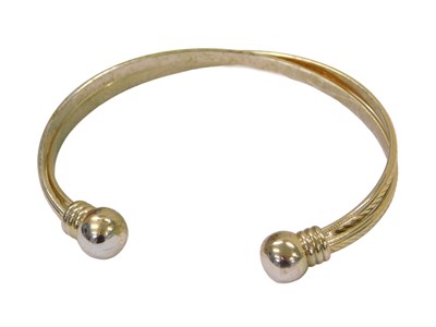 Lot 293 - A plated torc bangle, of two twist bar design,...
