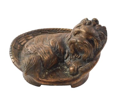 Lot 353 - A cast figure of a dog seated in basket, with...