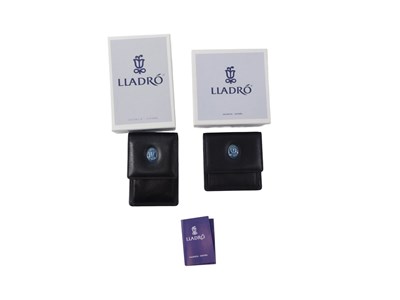 Lot 699 - Two Lladro porcelain leather wallets, each...
