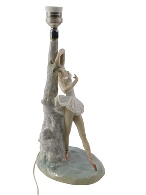 Lot 701 - A Lladro porcelain table lamp, depicting a...