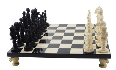 Lot 518 - A 20thC resin chess board and chess pieces.
