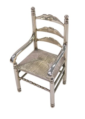 Lot 32 - A Dutch white metal miniature of a ladder back...