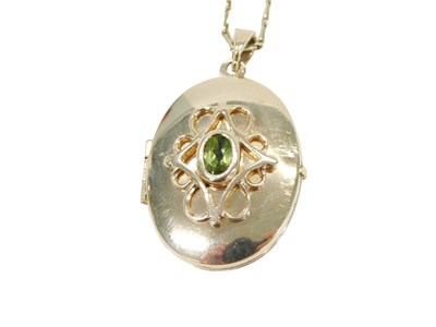 Lot 784 - A 9ct gold locket pendant and chain, the oval...