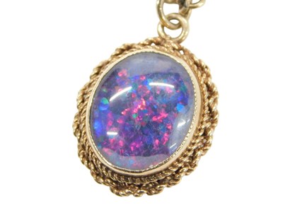 Lot 795 - A 9ct gold framed opal pendant, with twist...