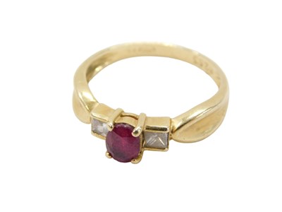 Lot 796 - A ruby and diamond dress ring, the oval cut...