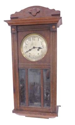 Lot 870 - A 1950s oak cased wall clock, with silvered...