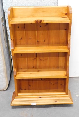 Lot 1524 - A pine hanging wall shelf.