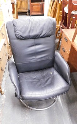 Lot 1545 - A black leatherette upholstered swivel armchair.
