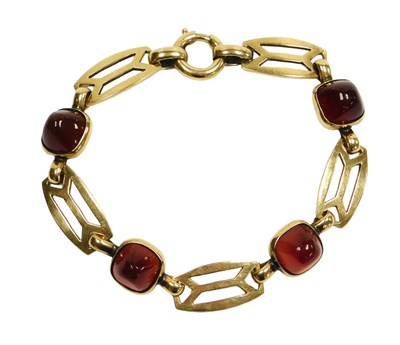 Lot 202 - An Arts & Crafts style cabochon garnet four...