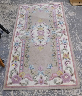 Lot 1592 - A Chinese woolwork rug, 71cm x 130cm.