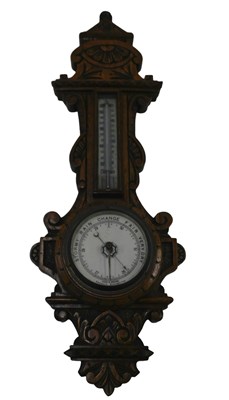Lot 753 - A Victorian carved oak aneroid barometer, with...
