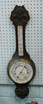 Lot 2157 - A mid 20thC oak cased aneroid barometer.