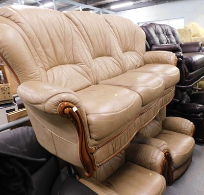 Lot 1613 - A taupe leather upholstered three seater sofa,...