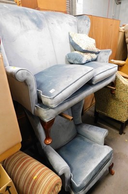 Lot 1618 - A two seater wingback armchair, upholstered in...