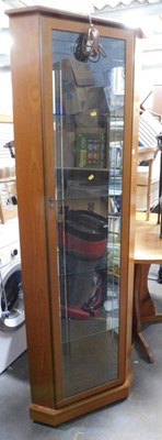 Lot 1622 - An oak corner display cabinet, the glass door...