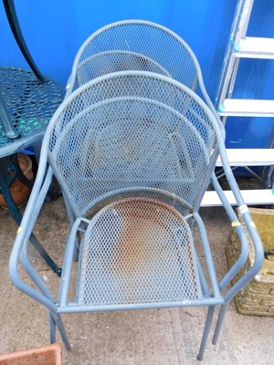 Lot 1679 - A set of four metal garden chairs, each with a...