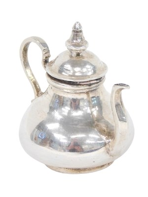 Lot 74 - A Dutch silver miniature teapot, of squat...
