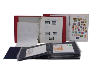 Lot 930 - An album containing first day covers, together...