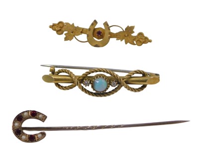 Lot 450A - A garnet and seed pearl horseshoe stick...