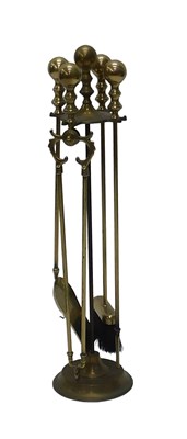 Lot 1041 - A brass fireside companion, to include four...