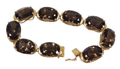 Lot 201 - A 9ct gold and smoky quartz bracelet, set with...