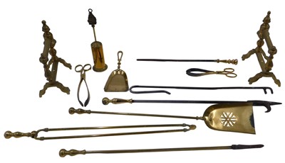 Lot 1048 - A collection of brass fire irons, fire dogs, etc.