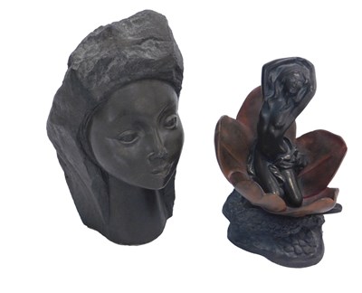 Lot 1101 - A bronzed resin figure of a nude within a...