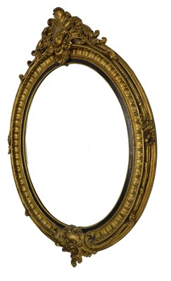 Lot 1151 - A large gilt gesso oval wall mirror, with...