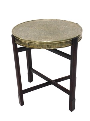 Lot 1155 - An Indian brass tray table, the circular top...