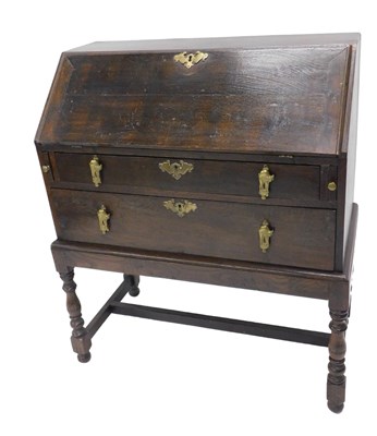 Lot 1159 - A 19thC dark oak bureau, with two long drawers,...