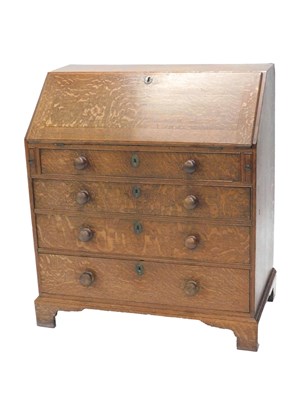 Lot 1176 - A George III oak bureau, the fall enclosing a...