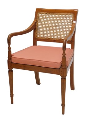 Lot 1185 - A pale hardwood open armchair, with caned back,...