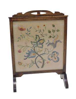 Lot 1195 - An early 20thC stained beech fire screen, with...