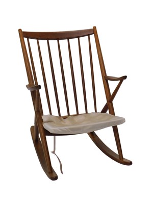Lot 1200 - A vintage teak rocking chair, with spindle...