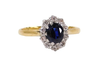 Lot 208 - A sapphire and diamond ring, the oval cut...
