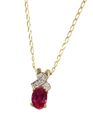 Lot 216 - A ruby and diamond pendant, the oval cut ruby...