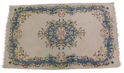 Lot 1237 - An Indian carpet, with a floral design on a...