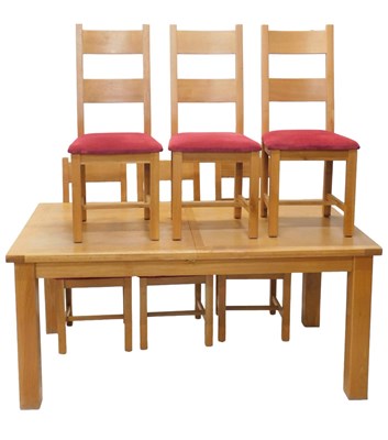 Lot 1263 - A light oak extending dining table, on square...