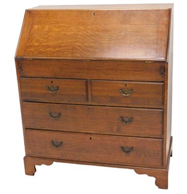 Lot 1280 - A George III style oak bureau, the fall...