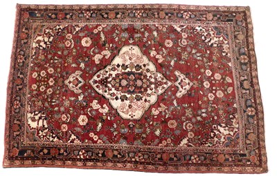 Lot 1294 - A Persian rug, with a central floral medallion...